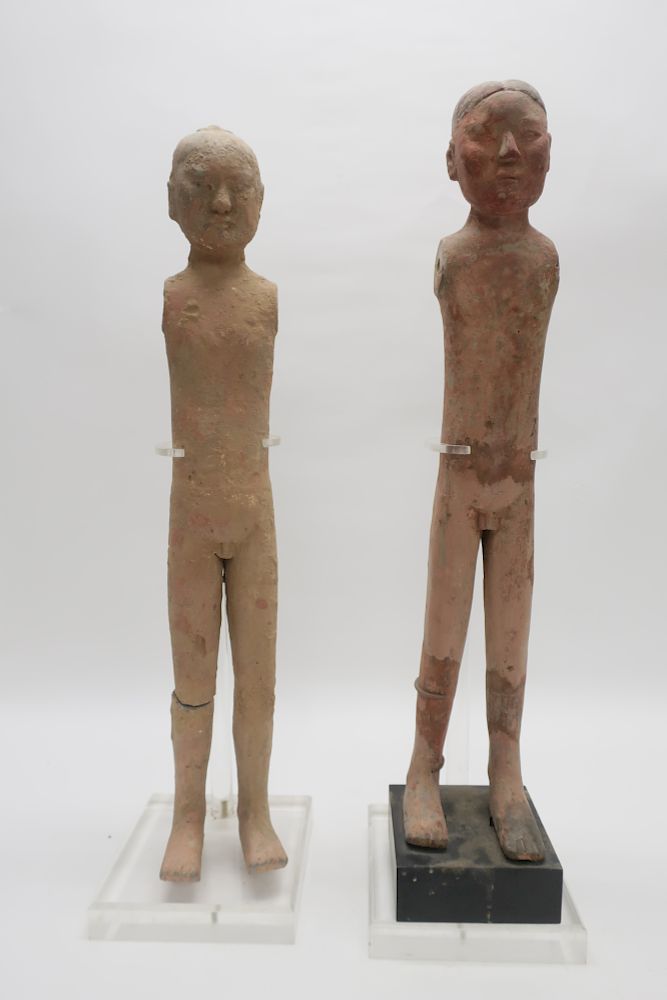 Appraisal: Two Han Stick Figures Two terracotta stick boy figures from