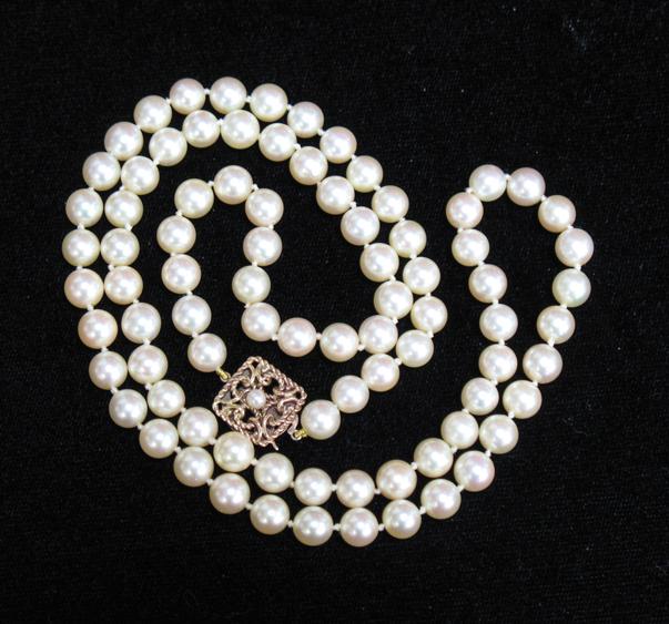 Appraisal: A LONG ROW OF CULTURED PEARLS with a ct yellow