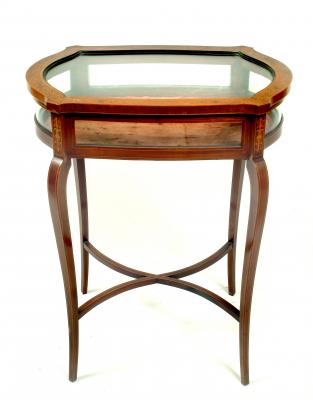 Appraisal: AN EDWARDIAN MAHOGANY BIJOUTERIE TABLE of mildly serpentine oblong form