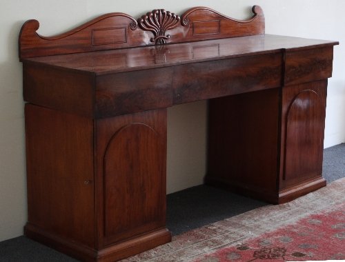 Appraisal: A Victorian mahogany pedestal sideboard with scrolling backboard fitted three