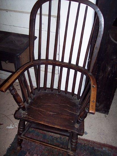 Appraisal: A Windsor chair the hoop back above arms on turned