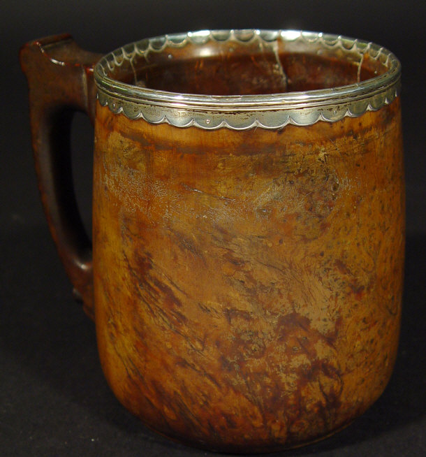 Appraisal: th Century fruitwood tankard with silver metal mount to the