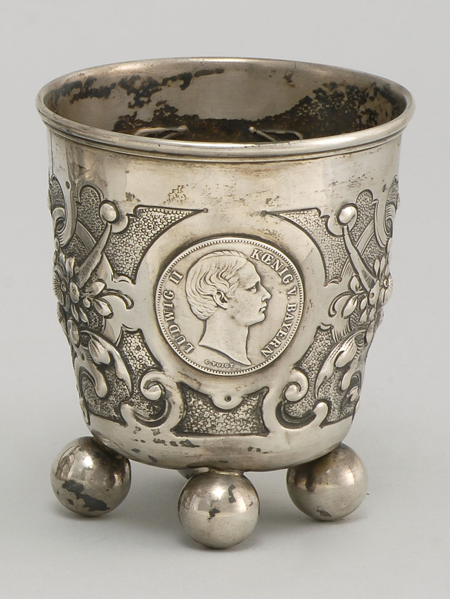 Appraisal: CONTINENTAL SILVER FOOTED CUP Chased fruit and scroll designs Ball