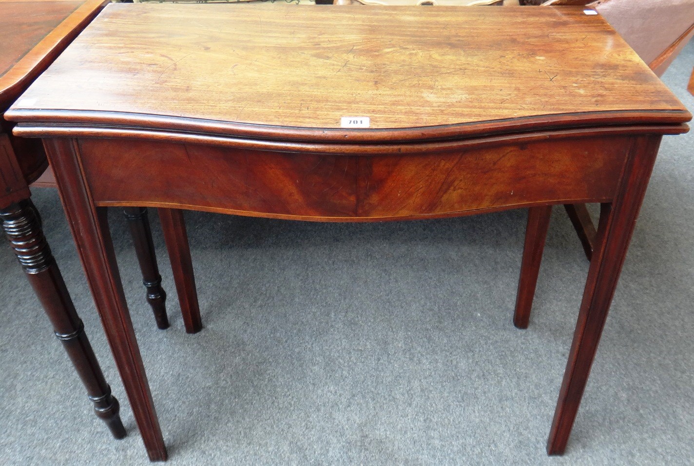 Appraisal: A George III mahogany tea table with serpentine top on