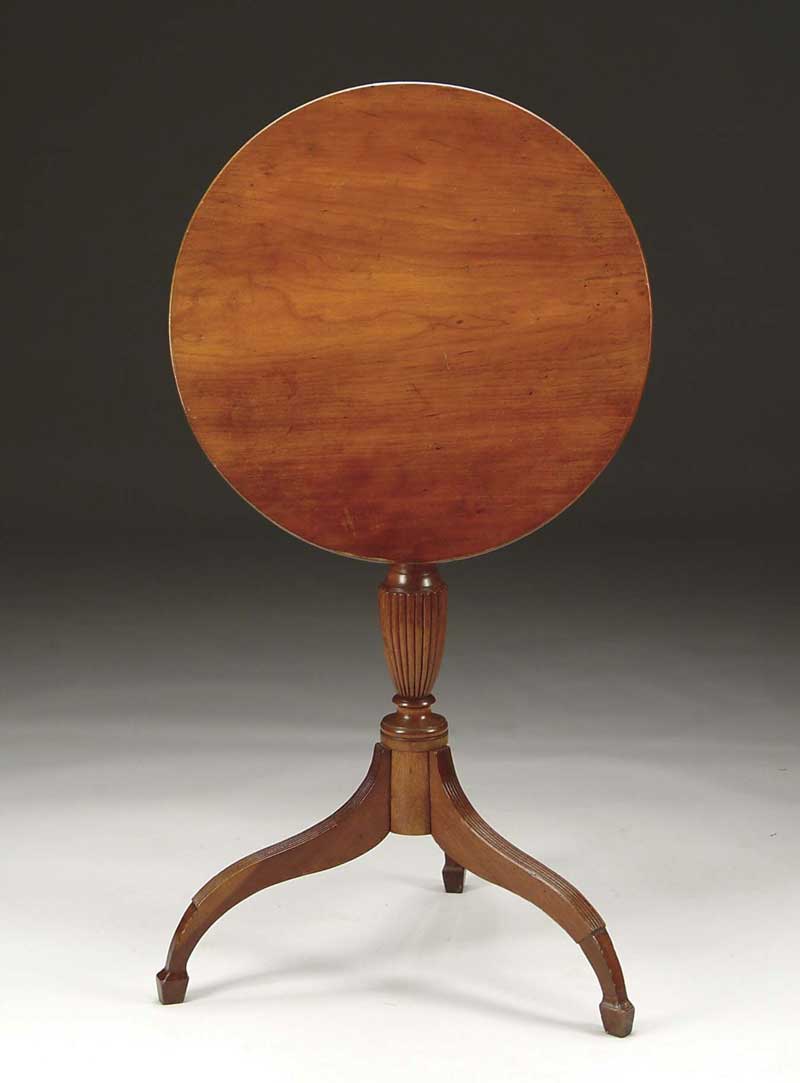 Appraisal: ROUND TILT TOP CANDLESTAND Cherry New England stand has ribbed