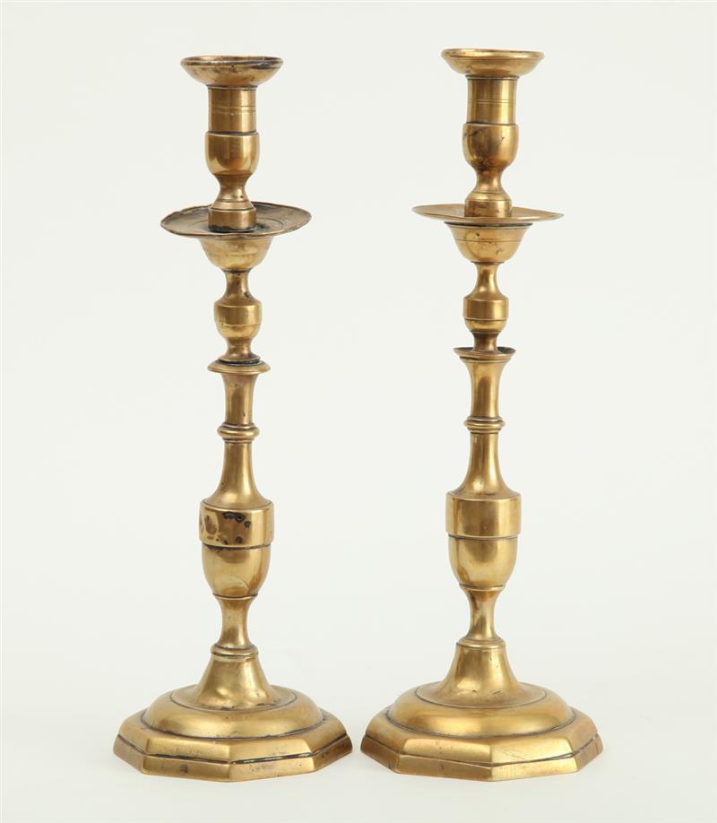 Appraisal: PAIR OF CONTINENTAL BAROQUE BRASS TALL CANDLESTICKS The tiered urn