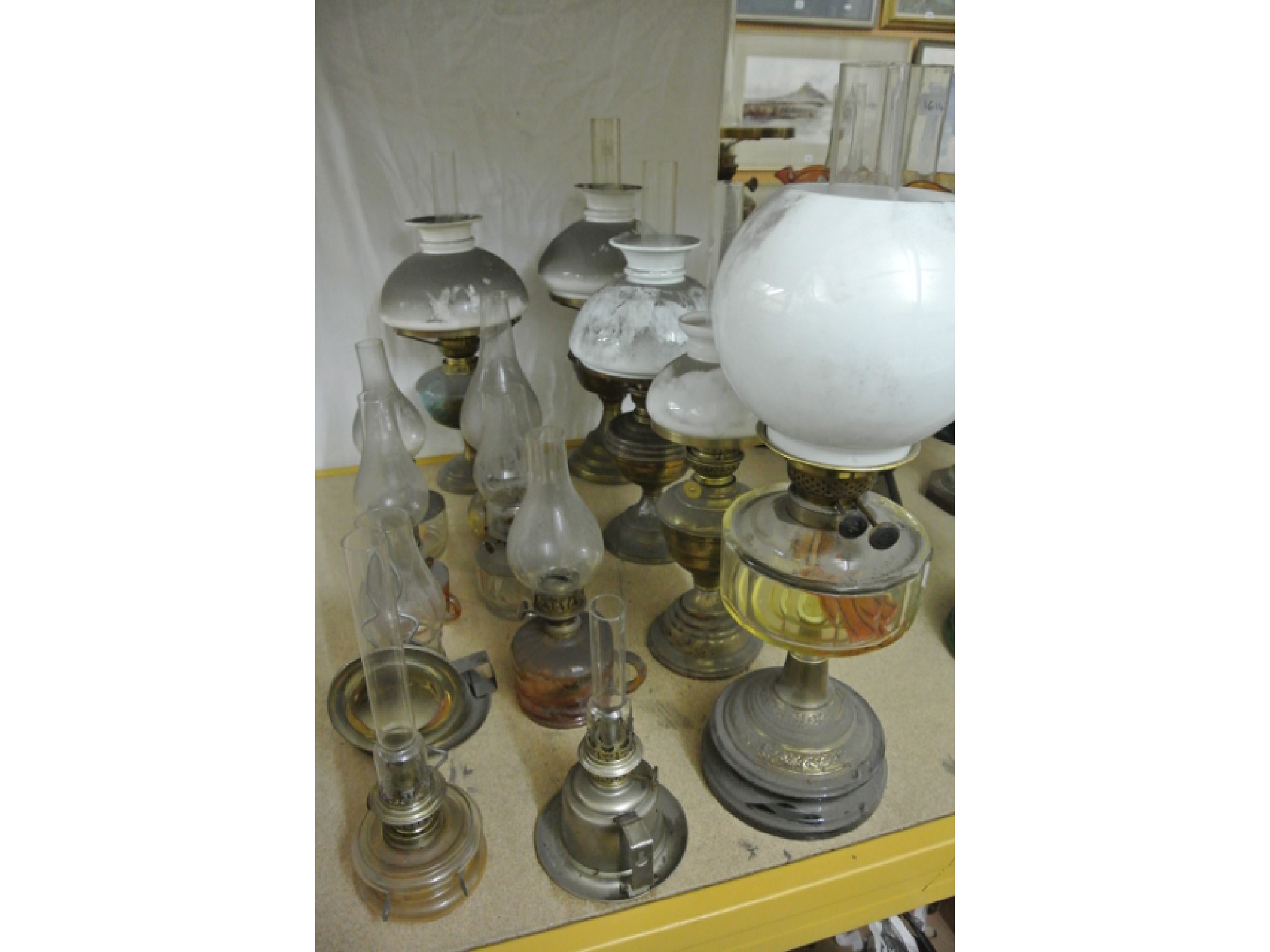 Appraisal: A Victorian oil lamp with globular milk glass shade brass