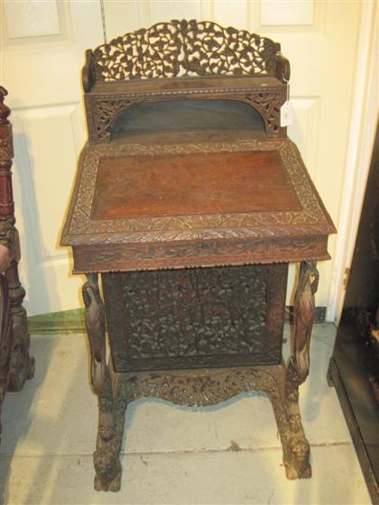 Appraisal: Ceylon carved hardwood davenport th century