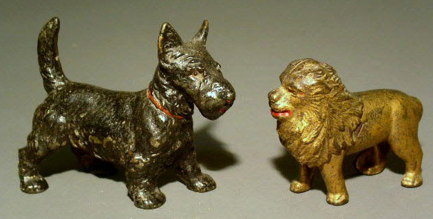 Appraisal: Cast iron lion bank h and a standing Scottie dog