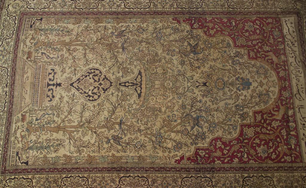 Appraisal: KASHAN PRAYER RUG c the pale biscuit-coloured mihrab filled with