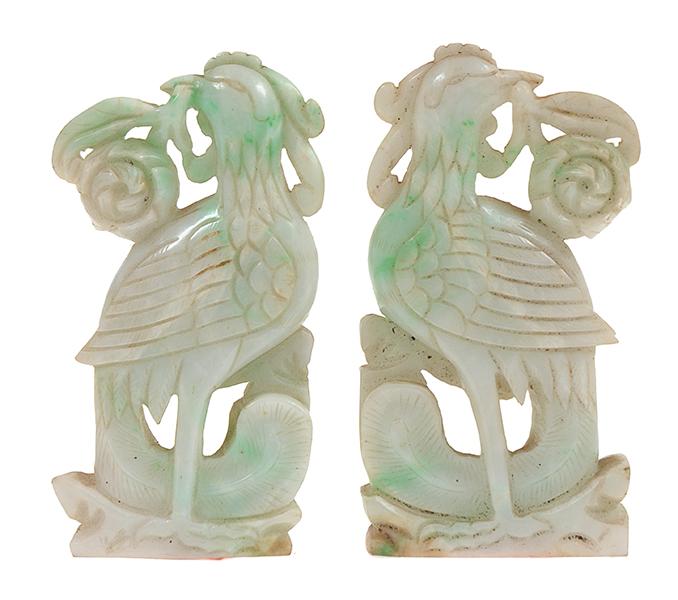 Appraisal: A PAIR OF CARVED CHINESE GREENSTONE FENGHUANG TH TH CENTURY