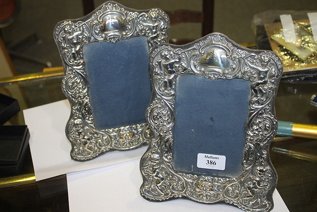 Appraisal: A PAIR OF SILVER PHOTOGRAPH FRAMES of shaped rectangular form