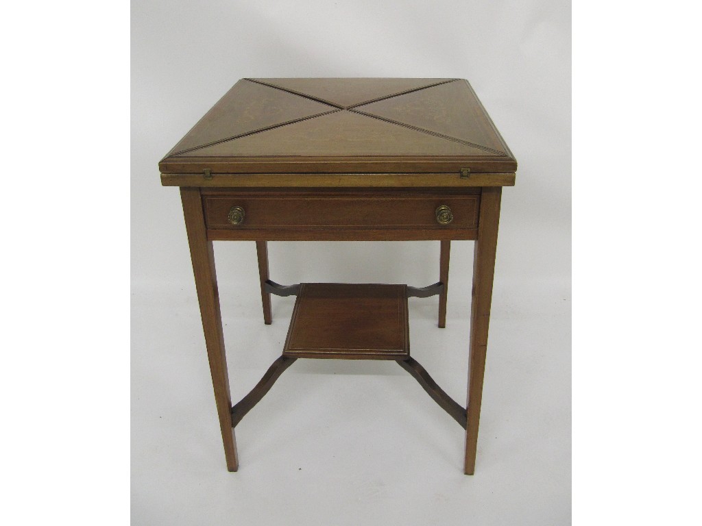 Appraisal: An Edwardian mahogany inlaid envelope card table with an undertier