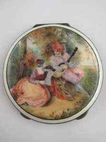 Appraisal: A silver compact decorated with a romantic scene in enamel