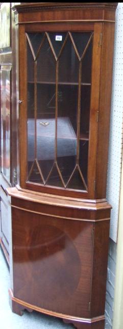 Appraisal: A th century mahogany floor standing corner cupboard the dentil