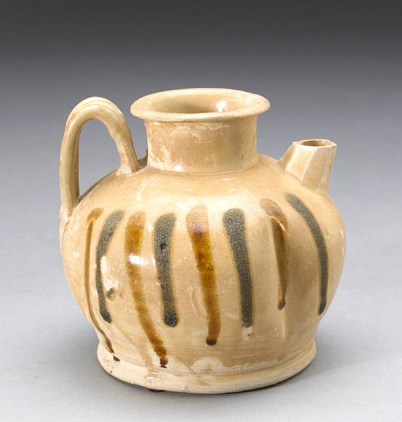 Appraisal: A Changsha glazed pottery ewer Tang Dynasty Of melon form