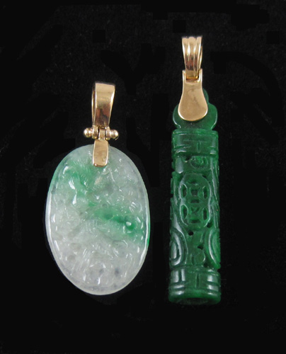 Appraisal: TWO CARVED GREEN JADE PENDANTS both Chinese pendants having k