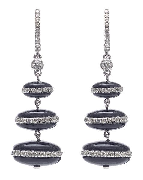 Appraisal: A PAIR OF DIAMOND AND ONYX EARRINGS Styled as three