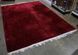 Appraisal: Chinese floral sculpted wine colored rug ' x Chinese floral