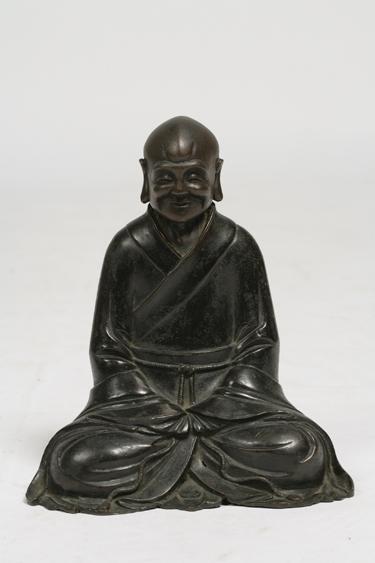 Appraisal: A CHINESE BRONZE OF A LOHAN his simple gown tied