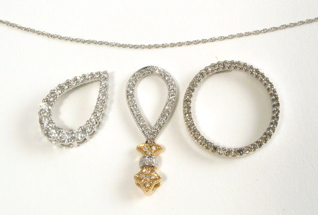 Appraisal: THREE PENDANTS AND A WHITE GOLD CHAIN One diamond and