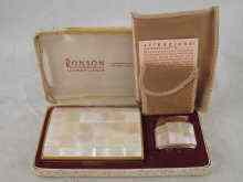 Appraisal: A boxed set comprising a Ronson gas lighter cased in