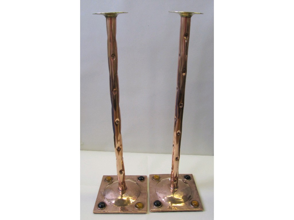 Appraisal: Pair of copper candlesticks with hammered decoration the base set