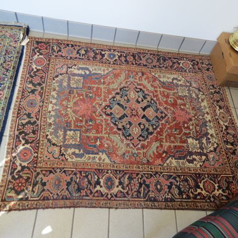 Appraisal: Heriz Persian Handmade Rug primarily blues reds ivory ' x