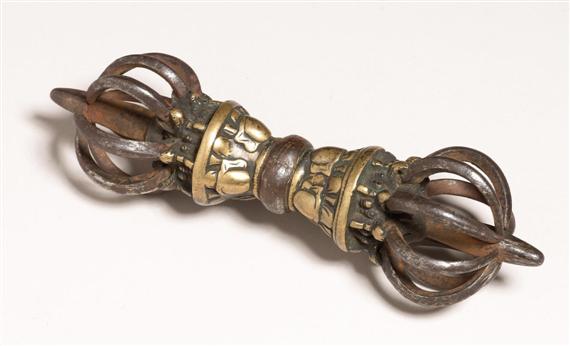 Appraisal: A POWERFUL IRON AND BRASS VAJRA Tibet th c or