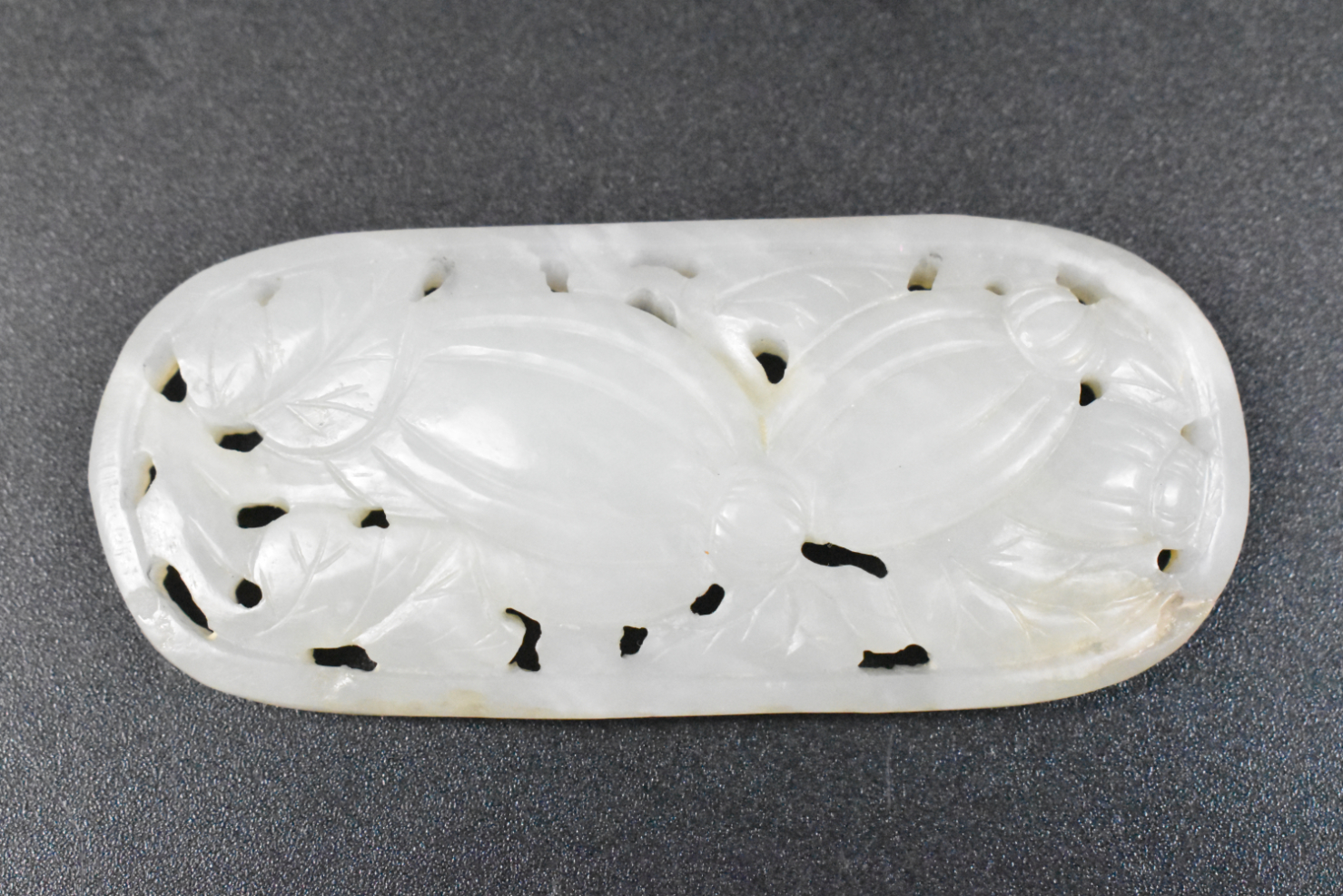 Appraisal: A Chinese white jade carved plaque with design featuring melons