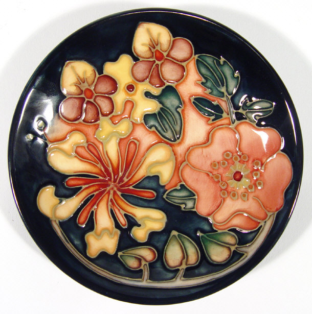 Appraisal: Moorcroft pottery dish hand painted and tubelined with flowers onto