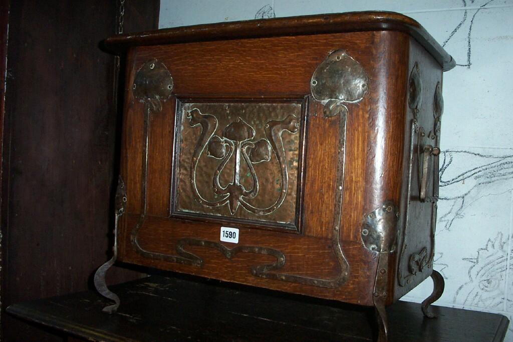 Appraisal: An Art Nouveau oak box with rising lid hammered copper