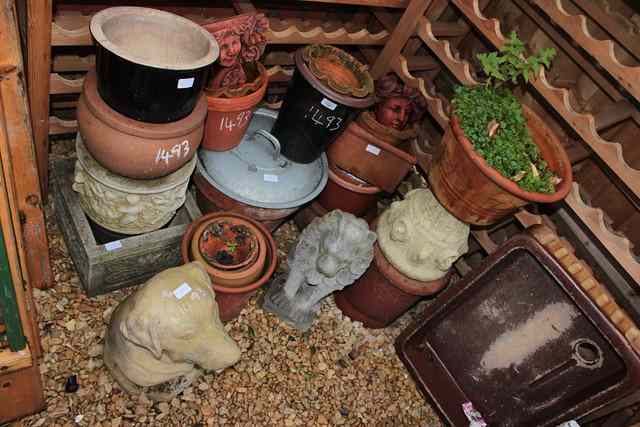 Appraisal: A STONEWARE SINK two concrete planters two teracotta wall ornaments