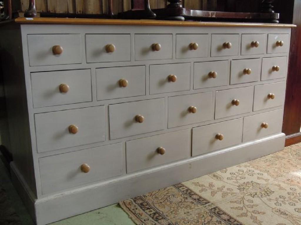 Appraisal: A painted pine counter fitted with an arrangement of twenty