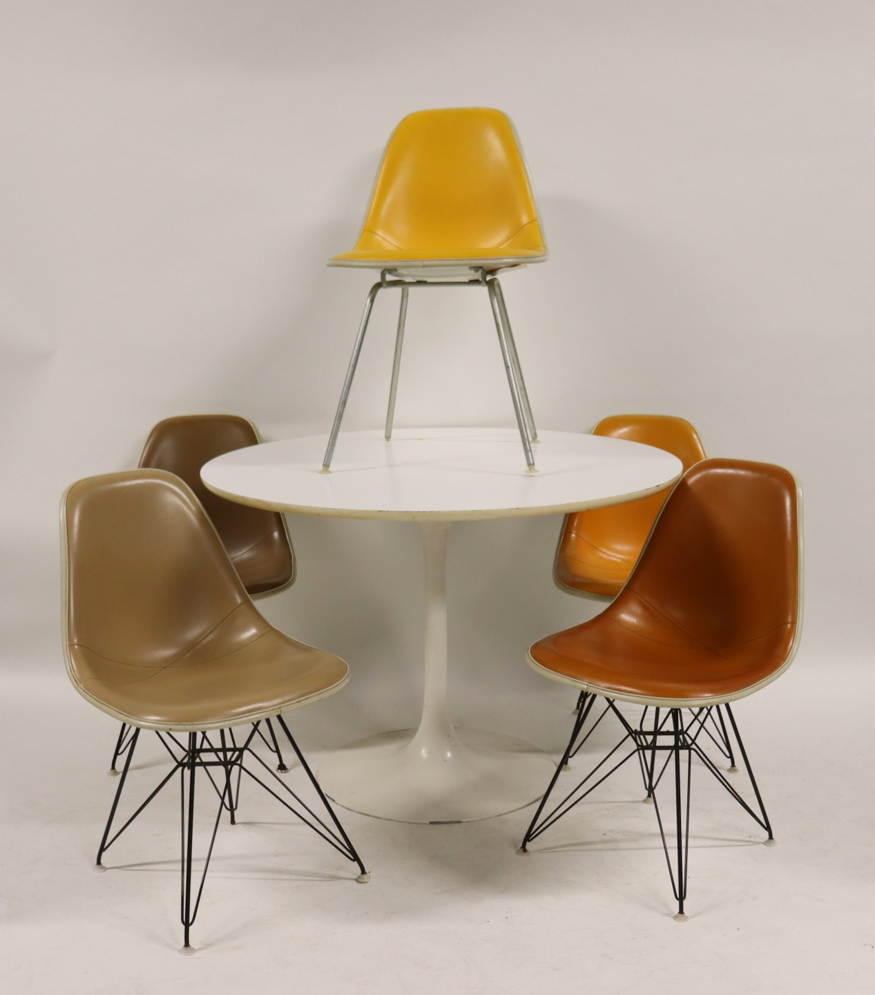 Appraisal: EAMES HERMAN MILLER CHAIRS A SAARINEN STYLE Table chairs with