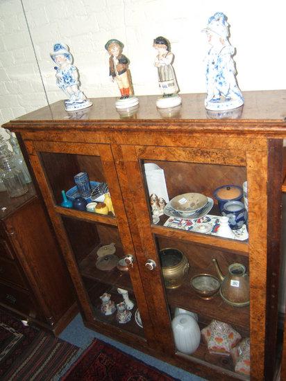 Appraisal: A burr walnut veneered bookcase with two glazed panel doors