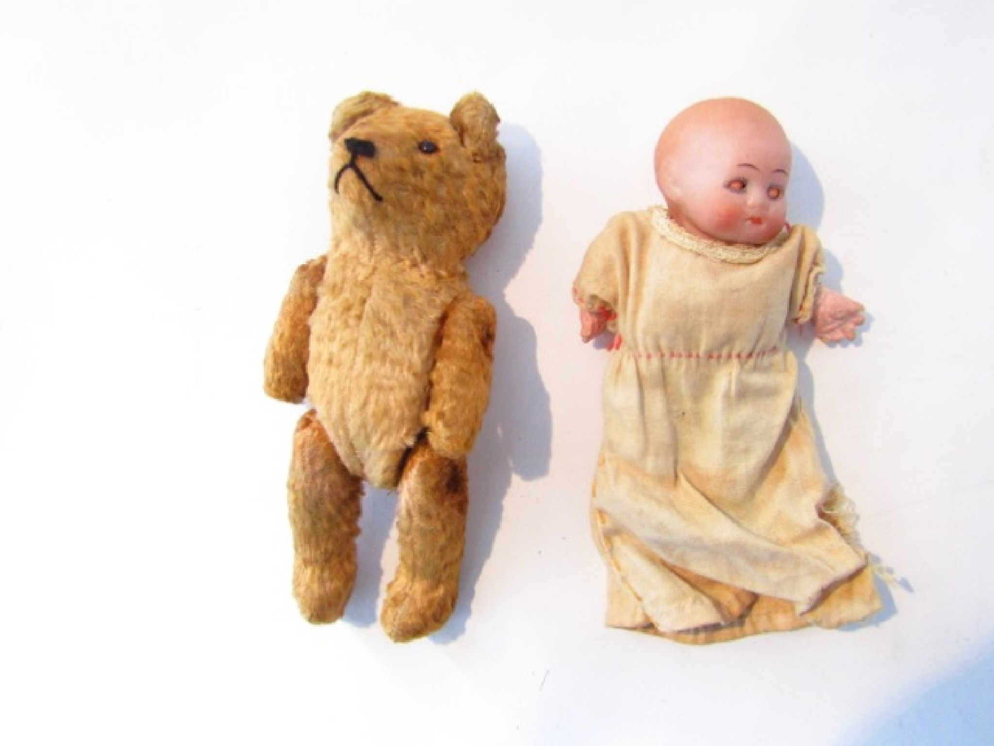 Appraisal: A small bisque head doll and a vintage straw filled