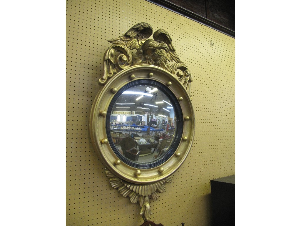 Appraisal: Convex circular wall mirror with eagle finial