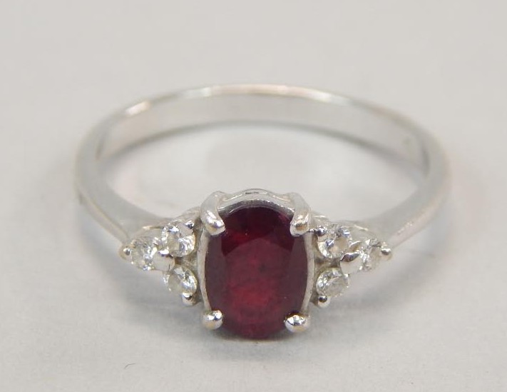 Appraisal: A ruby and diamond dress ring with central ruby flanked