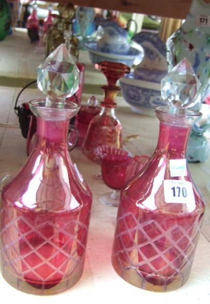 Appraisal: A pair of Victorian cranberry glass decanters and stoppers a