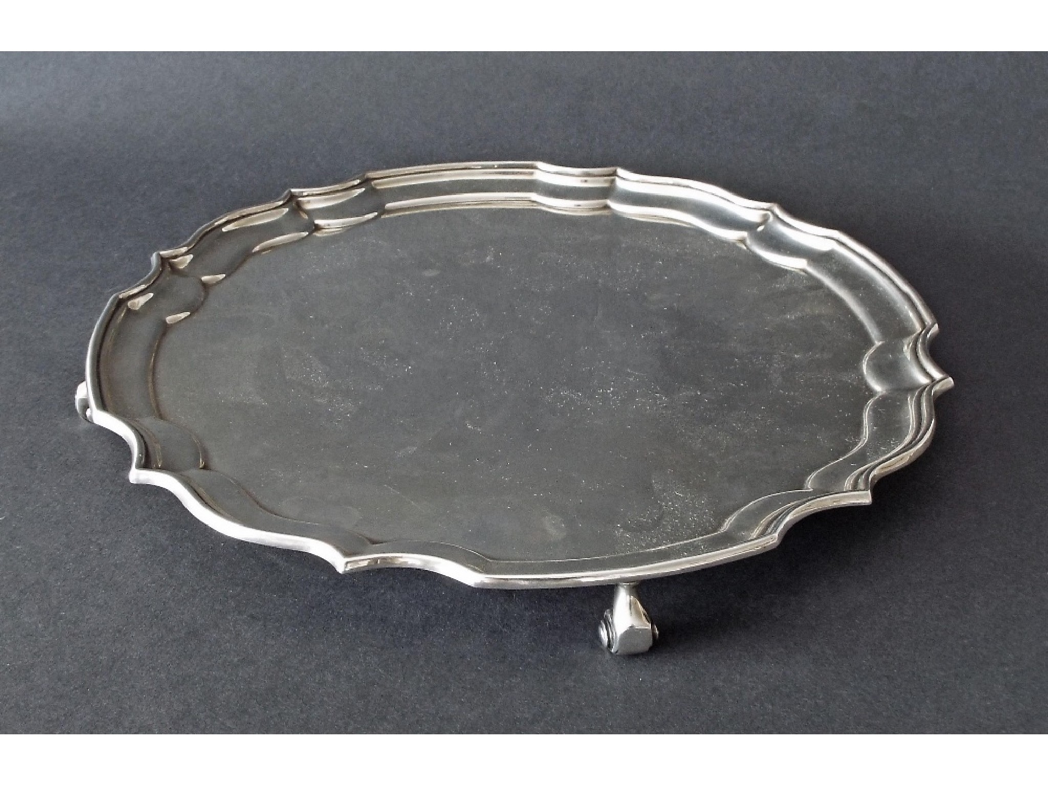 Appraisal: Georgian style silver salver with a pie-crust border upon four