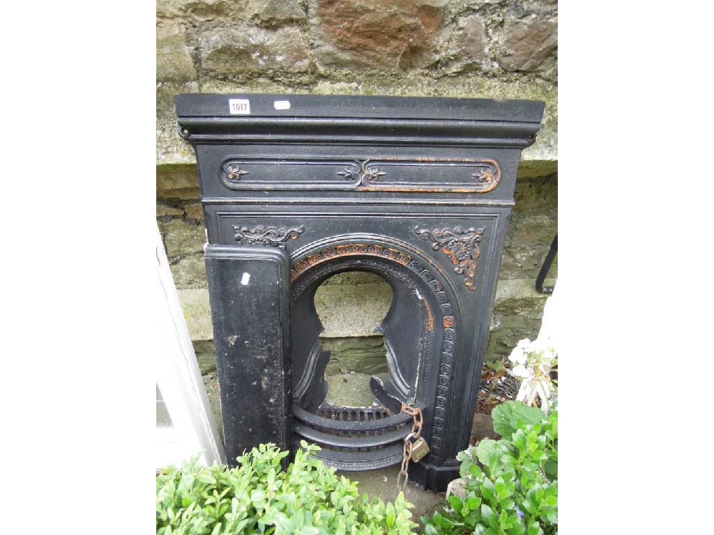 Appraisal: A small Victorian cast iron fireplace with raised relief foliate