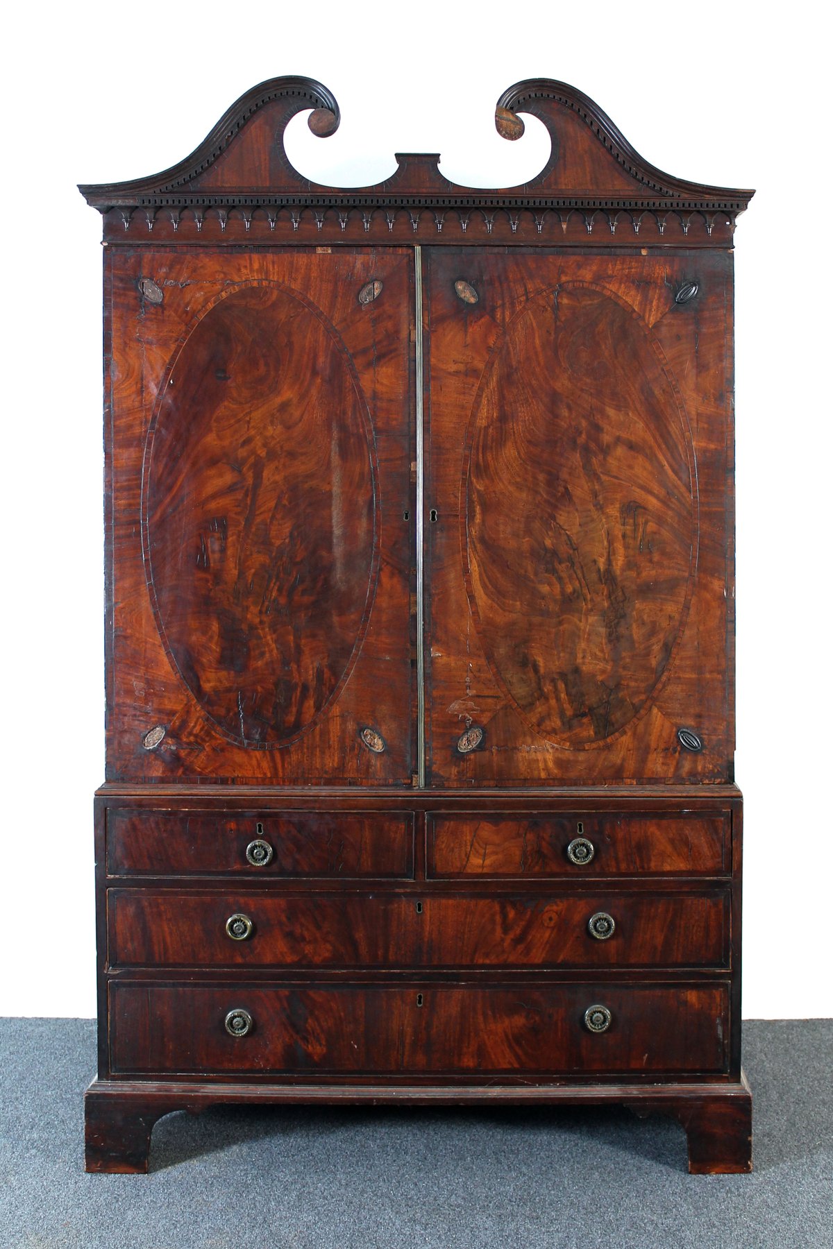 Appraisal: A George III mahogany linen press the broken swan neck