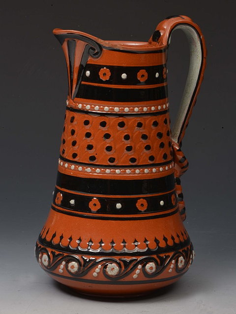 Appraisal: A WATCOMBE TERRACOTTA GLAZED JUG with enamel decoration designed by