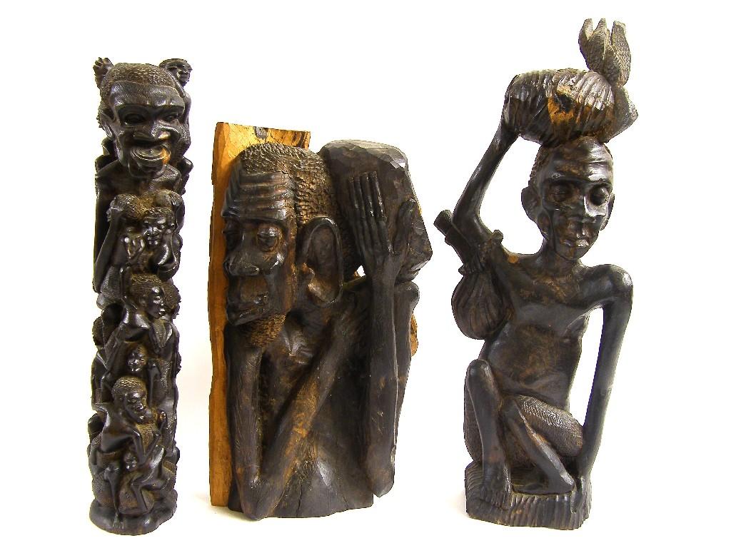 Appraisal: African tribal lignum vitae carving modelled as multiple tribesmen clambering