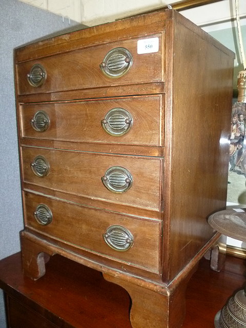 Appraisal: A GEORGIAN STYLE SMALL CHEST of four long drawers standing