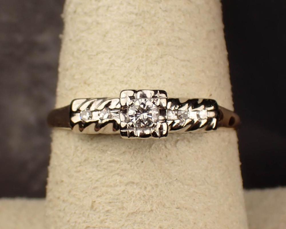 Appraisal: DIAMOND AND FOURTEEN KARAT GOLD RING The white and yellow