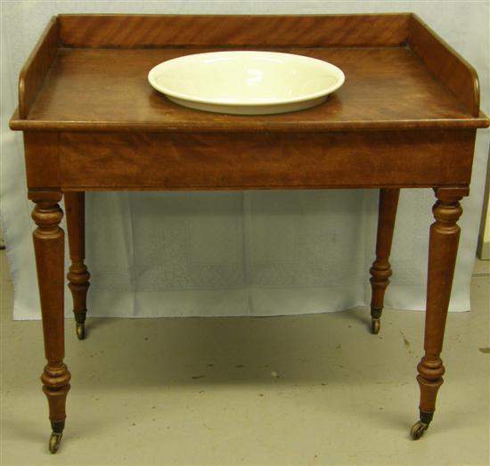 Appraisal: th century mahogany wash stand with gallery back turned legs