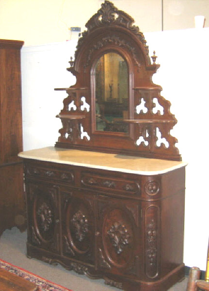 Appraisal: AMERICAN ROCOCO REVIVAL WALNUT SIDEBOARD With elaborate arched mirror back