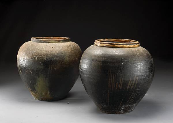 Appraisal: Two large brown glazed terracotta storage jars Each wide mouthed